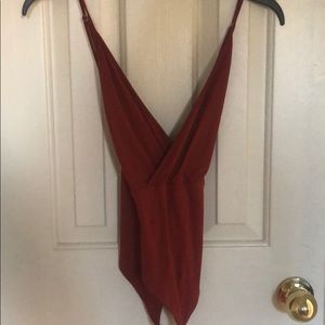 Burnt orange body suit